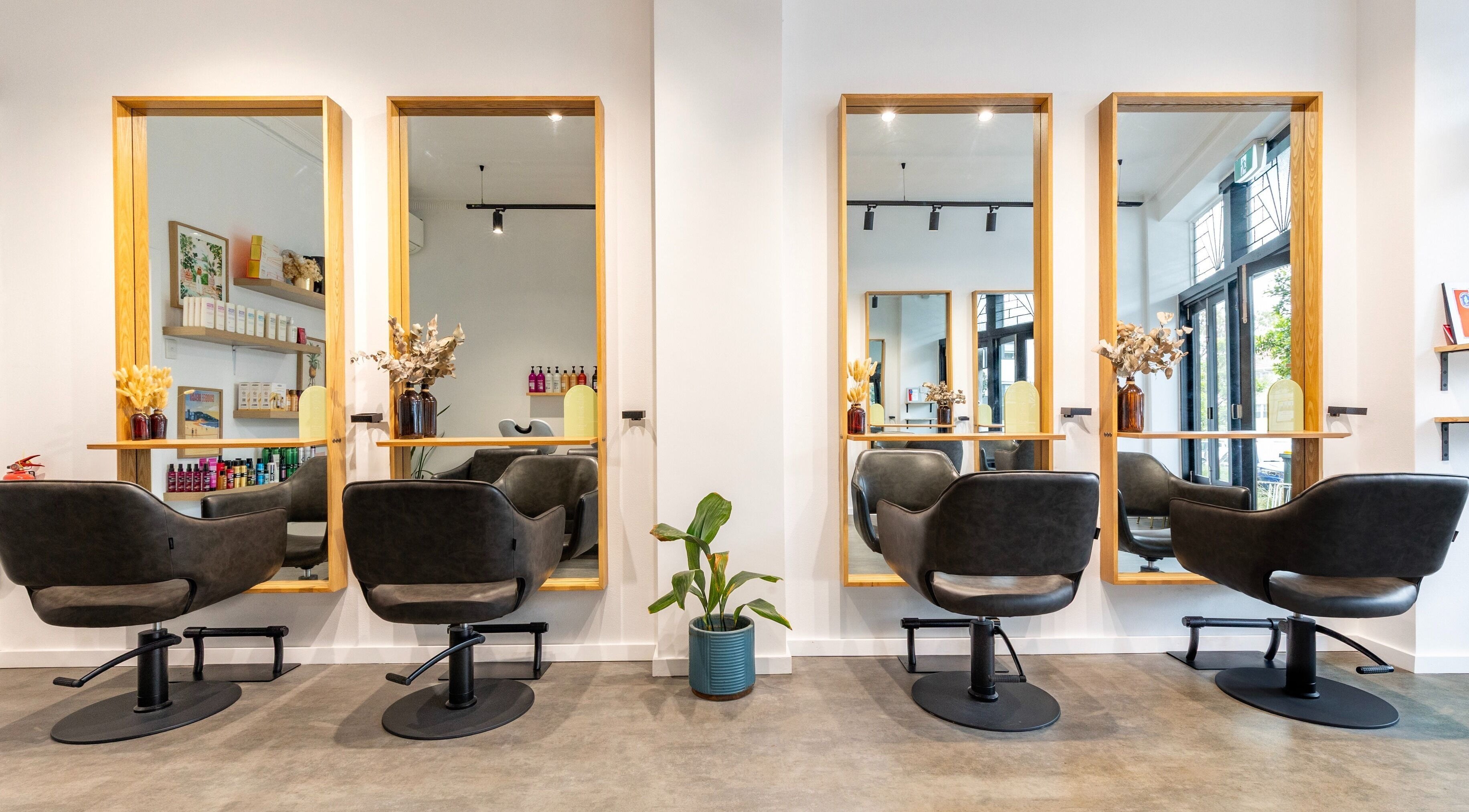 Elegant salon chairs and mirrors at Collective and Co Coogee, Coogee, New South Wales, AU, creating a stylish atmosphere.