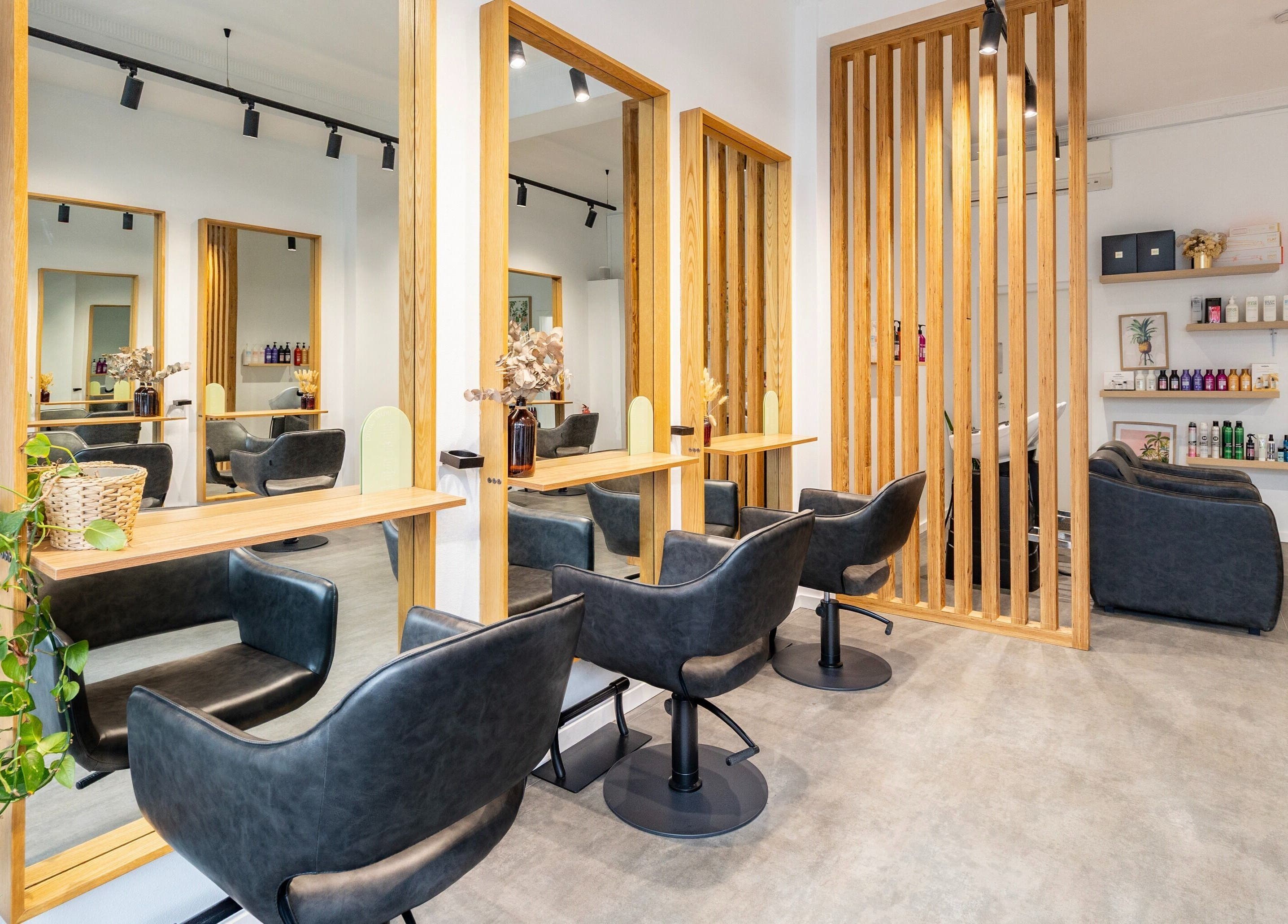 Modern salon interior at Collective and Co Coogee, Coogee, New South Wales, AU, featuring sleek black chairs.