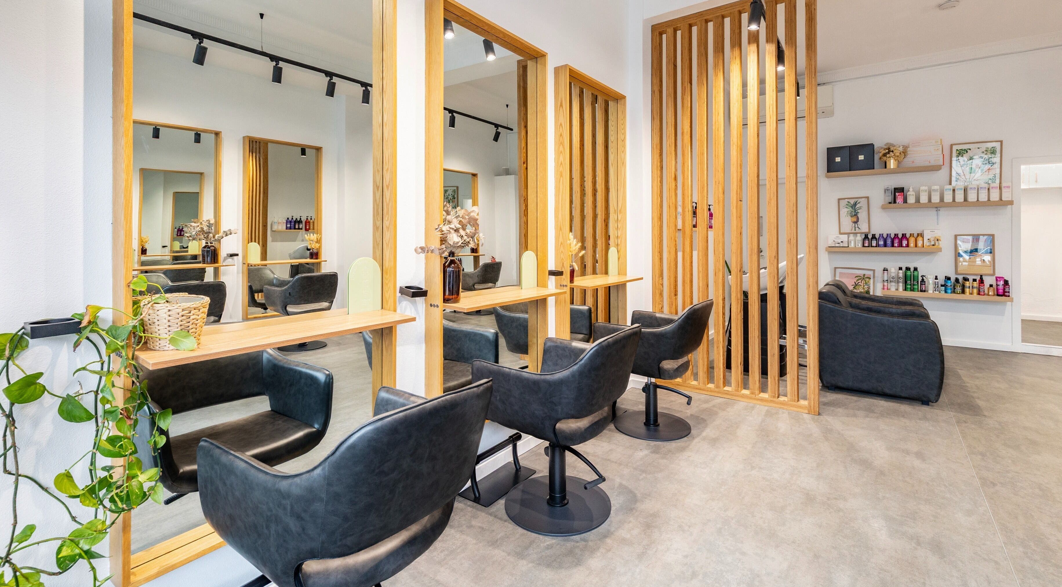 Modern salon interior at Collective and Co Coogee, Coogee, New South Wales, AU, featuring sleek black chairs.