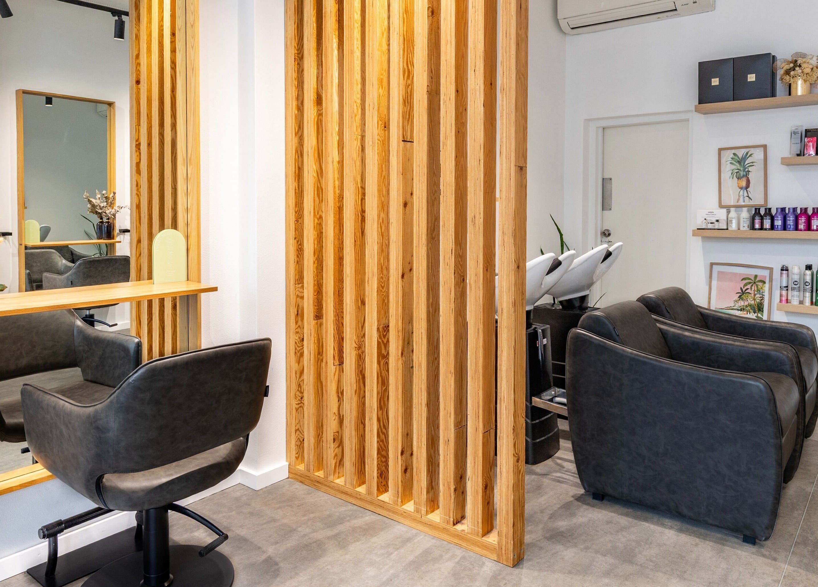 Stylish salon interior at Collective and Co Coogee in Coogee, New South Wales, AU featuring sleek seating and products.