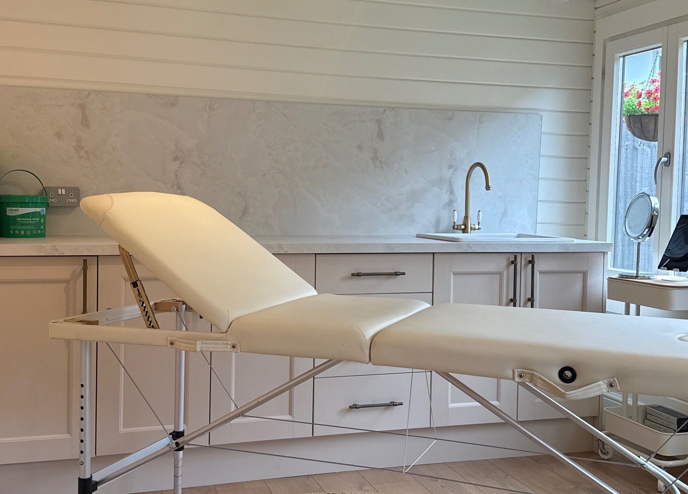 Cozy treatment room at Aesthetically pleasing by lottie, Banstead, England, GB featuring a comfortable spa bed.