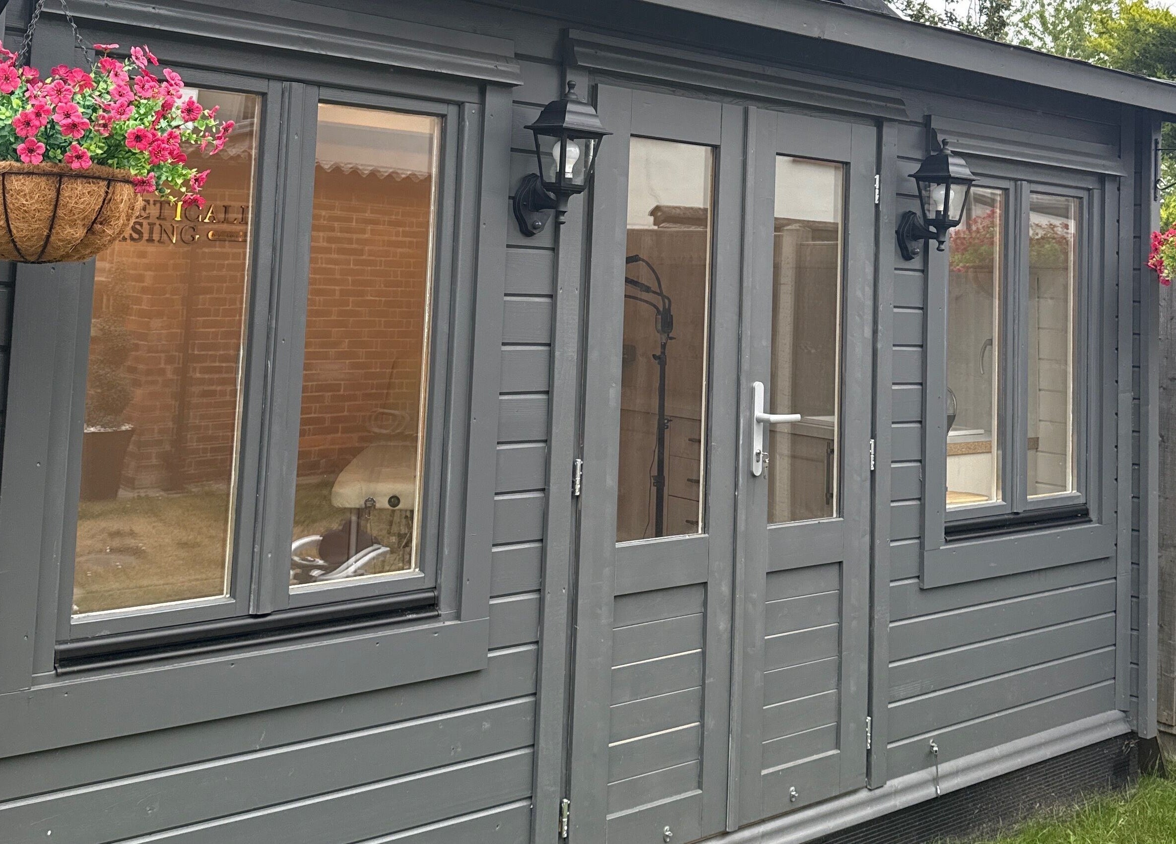 Elegant exterior view of Aesthetically pleasing by lottie in Banstead, England, GB with hanging flower baskets.