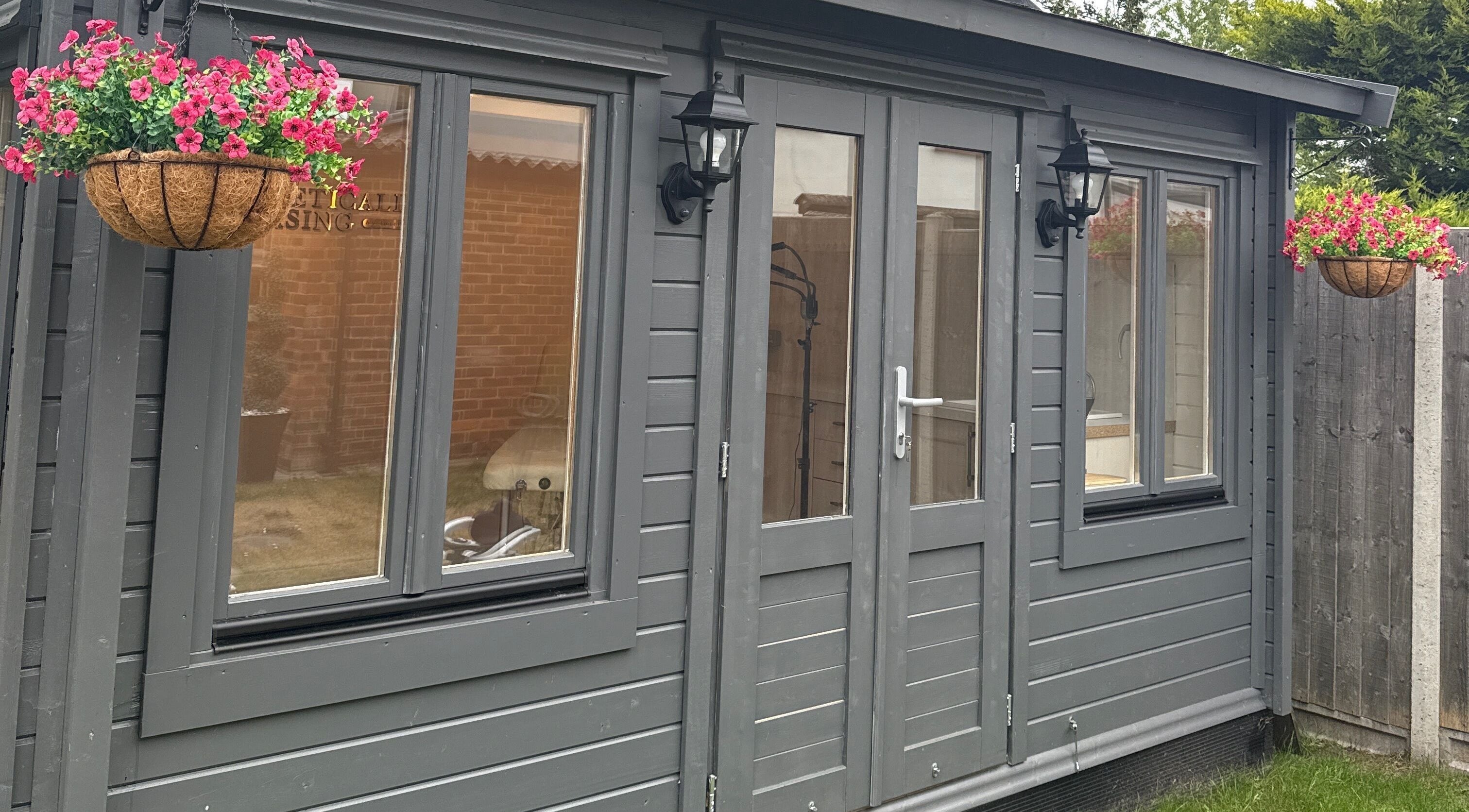 Elegant exterior view of Aesthetically pleasing by lottie in Banstead, England, GB with hanging flower baskets.