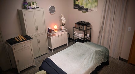 Tranquil massage room at Blue Orchid Massage in Denver, Colorado, US, featuring a cozy bed and ambient decor.