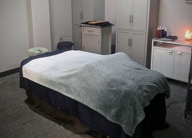 Relaxing massage room at Blue Orchid Massage, Denver, Colorado, US. Cozy bed with soothing decor.