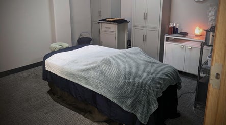 Relaxing massage room at Blue Orchid Massage, Denver, Colorado, US. Cozy bed with soothing decor.