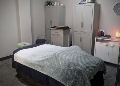 Relaxing massage room at Blue Orchid Massage in Denver, Colorado, US with a cozy therapy bed.