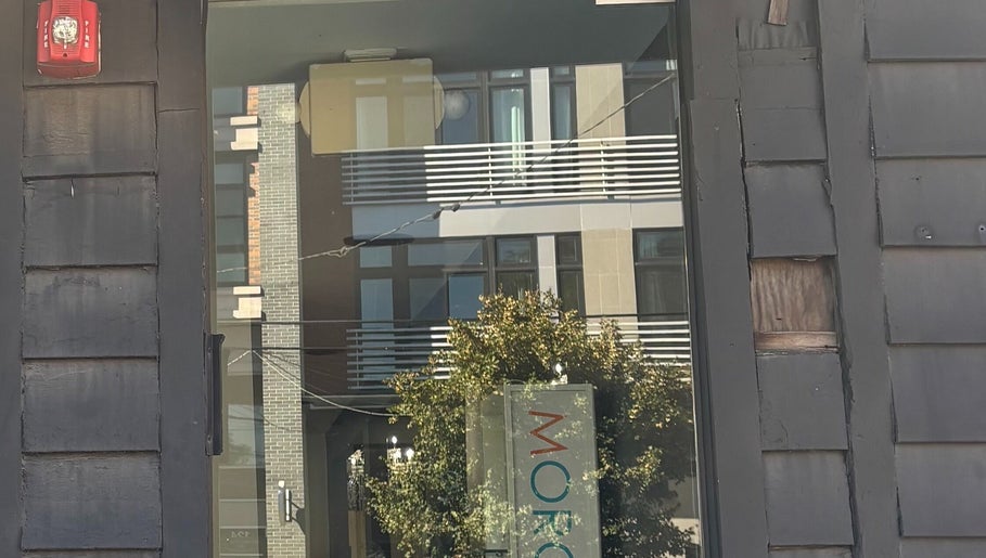 Entrance reflection at ASHIYA'S, Jersey City, New Jersey, US, showcasing sleek urban architecture.