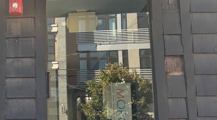 Entrance reflection at ASHIYA'S, Jersey City, New Jersey, US, showcasing sleek urban architecture.