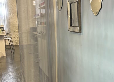 Chic interior of ASHIYA'S salon in Jersey City, New Jersey, US with mirrors and sleek decor.