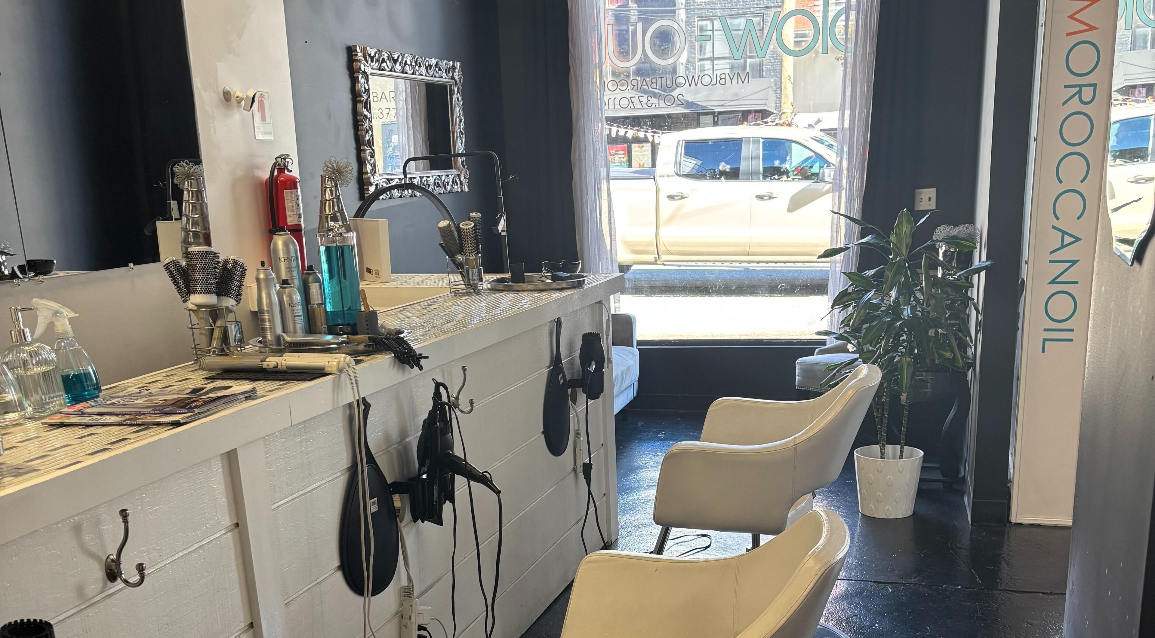 Stylish salon interior at ASHIYA'S in Jersey City, New Jersey, US showcasing chic decor and hair styling tools.