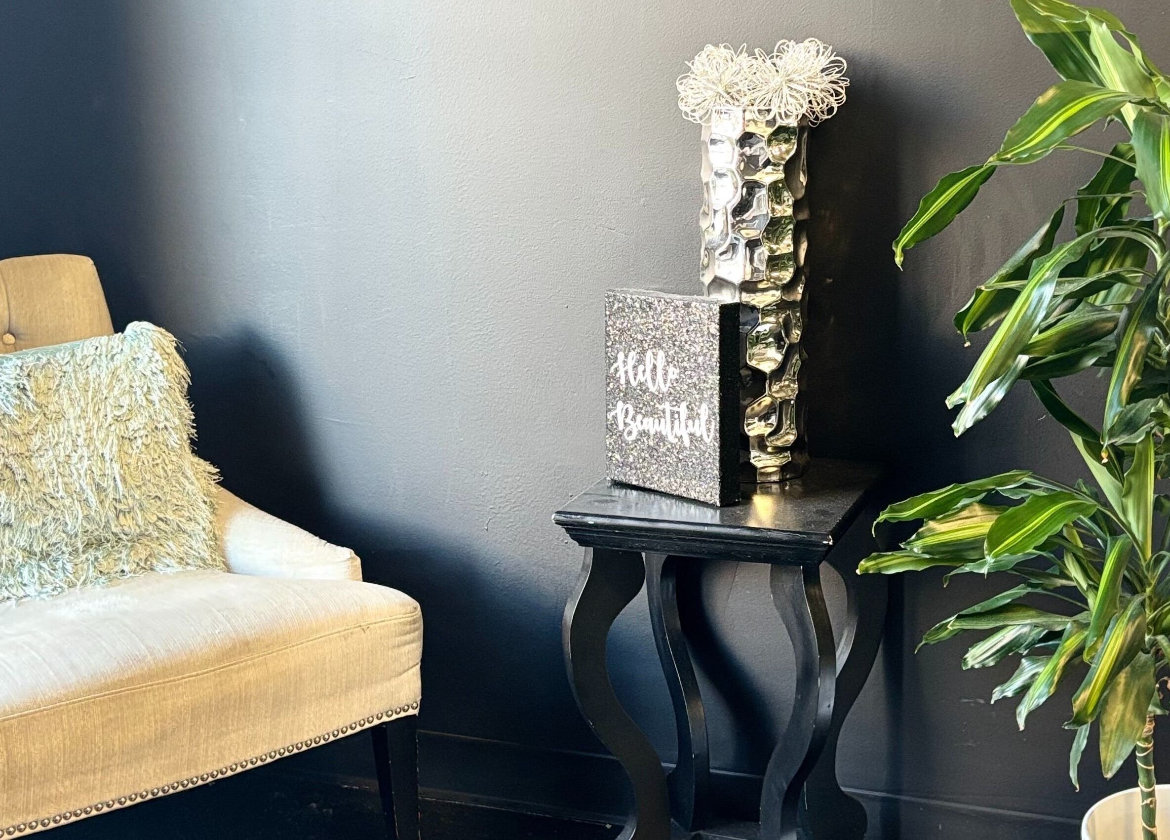 Elegant lounge area at ASHIYA'S, Jersey City, New Jersey, US with plush chair and decorative plant.