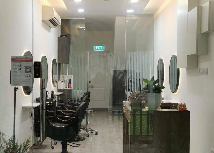 Modern salon interior at J of Salon, Singapore, SG featuring sleek chairs and illuminated mirrors.