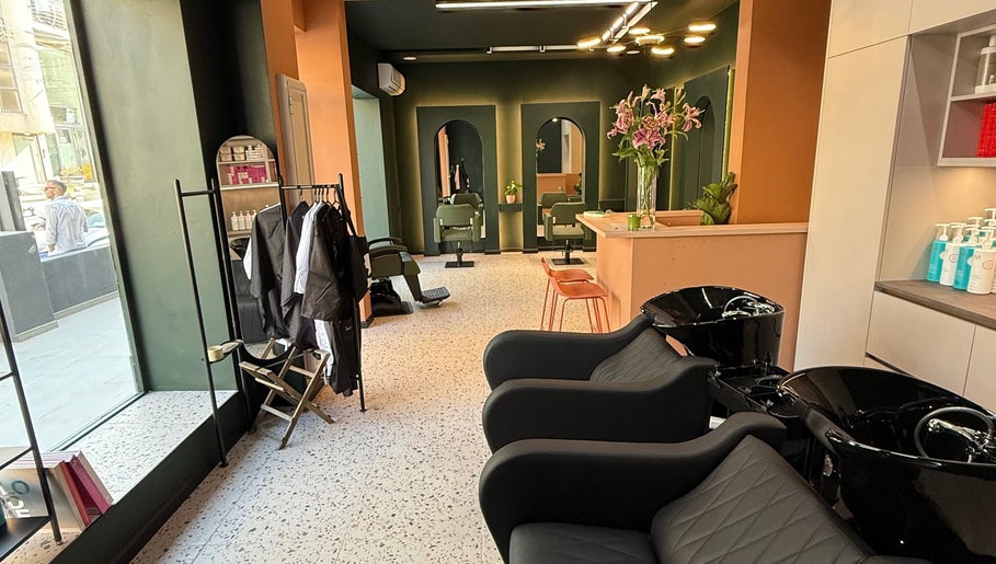 Stylish interior of soBlonde hair boutique, Naxxar, MT, featuring modern chairs and elegant design.