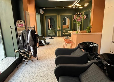 Stylish interior of soBlonde hair boutique, Naxxar, MT, featuring modern chairs and elegant design.