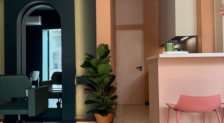 Stylish interior of soBlonde hair boutique in Naxxar, MT, featuring elegant decor and a lush green plant.