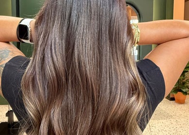 Stunning brunette hairstyle at soBlonde hair boutique in Naxxar, MT, showcasing silky, wavy locks.