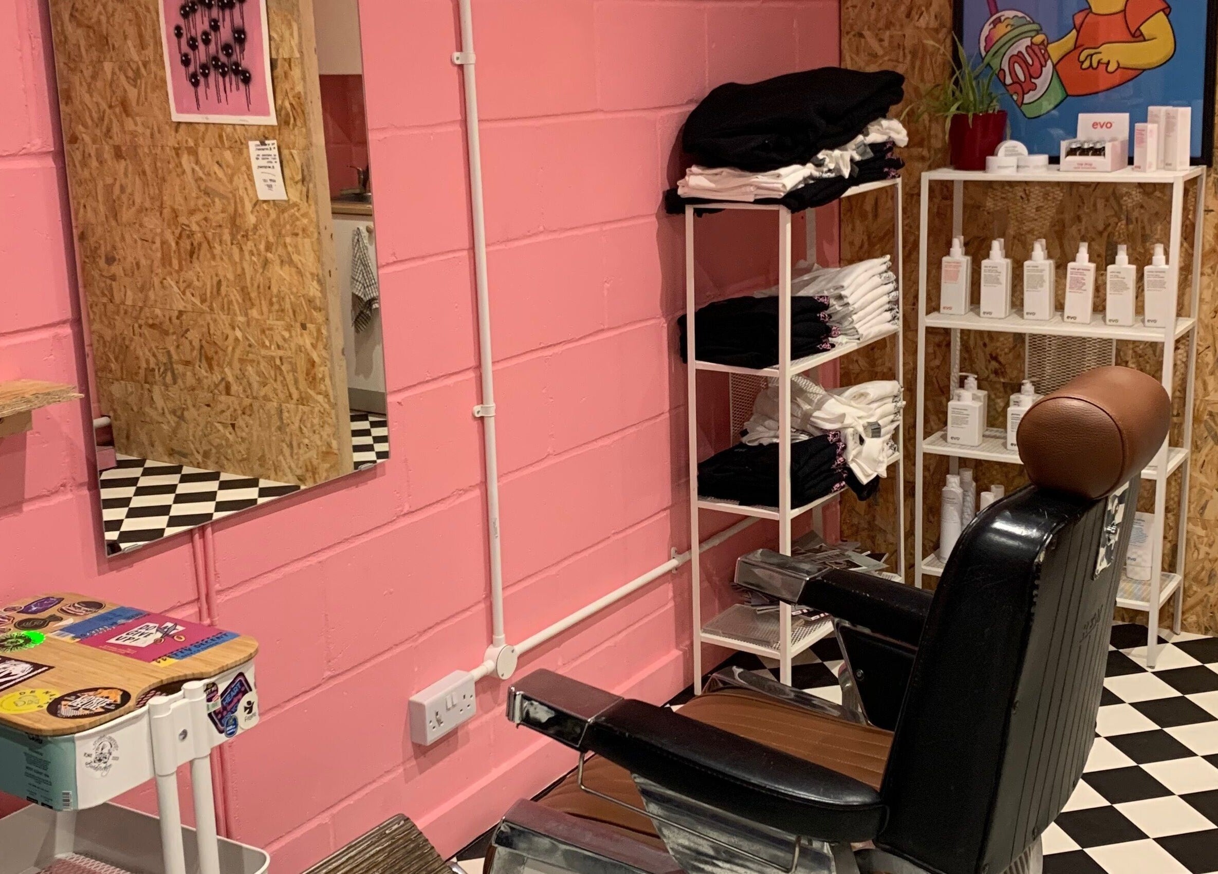 Vibrant salon interior at Little Trimz in London, England, GB, showcasing a stylish chair and colorful decor.