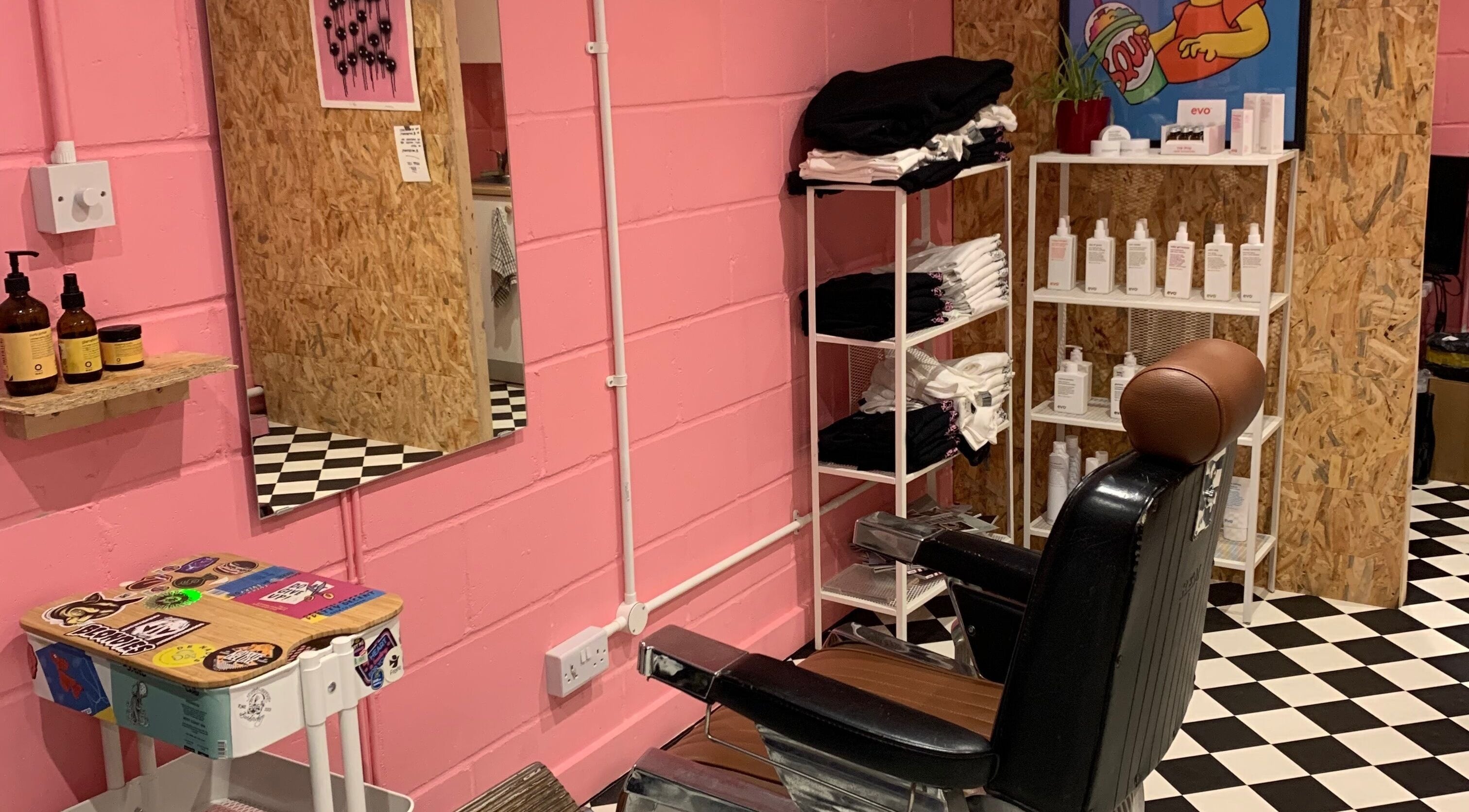 Vibrant salon interior at Little Trimz in London, England, GB, showcasing a stylish chair and colorful decor.