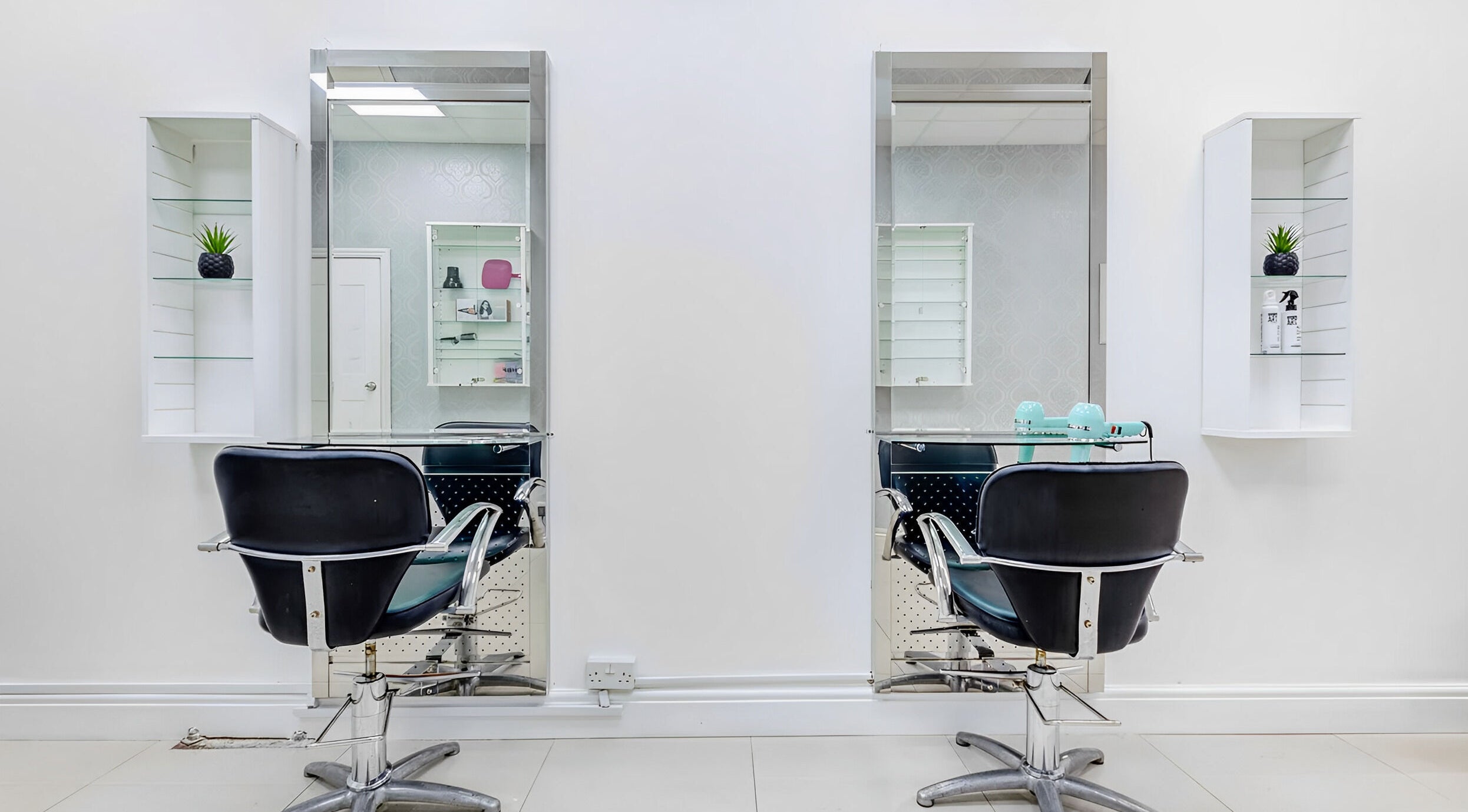 Elegant hair styling chairs at Tropics Hair and Beauty, Hounslow, England, GB, showcasing modern salon decor.