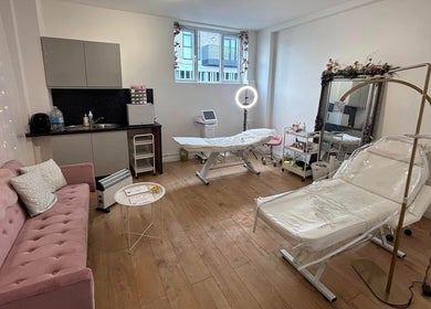 Cozy treatment room at Mia Bella - Wilmslow, Wilmslow, England, GB with pink couch and beauty equipment.