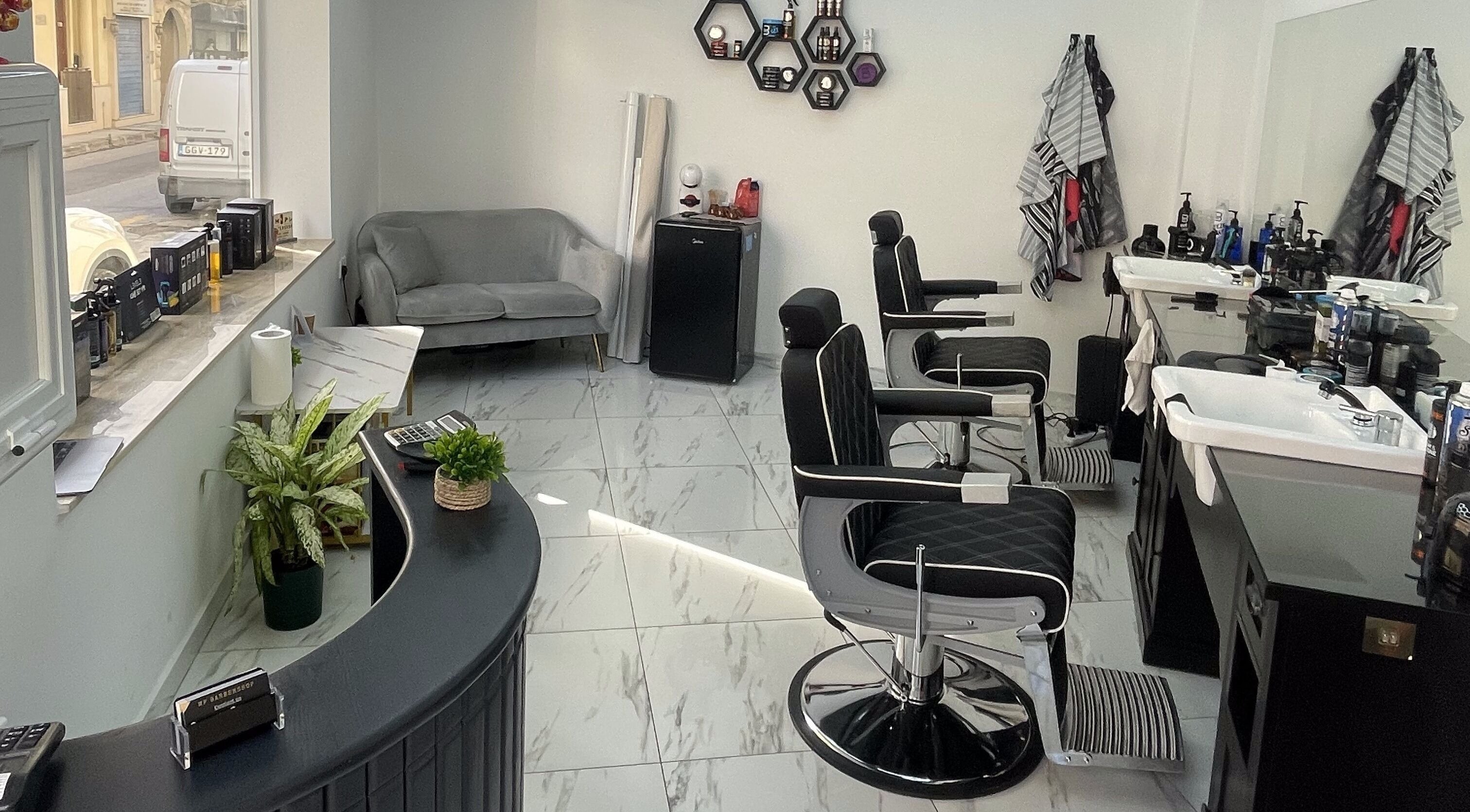 Modern interior of MP Barbershop, Birkirkara, MT with sleek chairs and stylish decor.