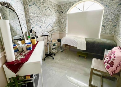 Serene treatment room at Derma Lift Studio, Winthrop, Western Australia, AU, featuring a massage bed and floral decor.