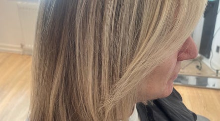 Smooth blonde hair styled at Ali @ No. 17, East Kilbride, Scotland, GB showcasing sleek salon results.