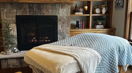 Massage bed near fireplace at AQUILA HEALTH & BEAUTY Dubai| Home Services in Dubai, Dubai, AE.