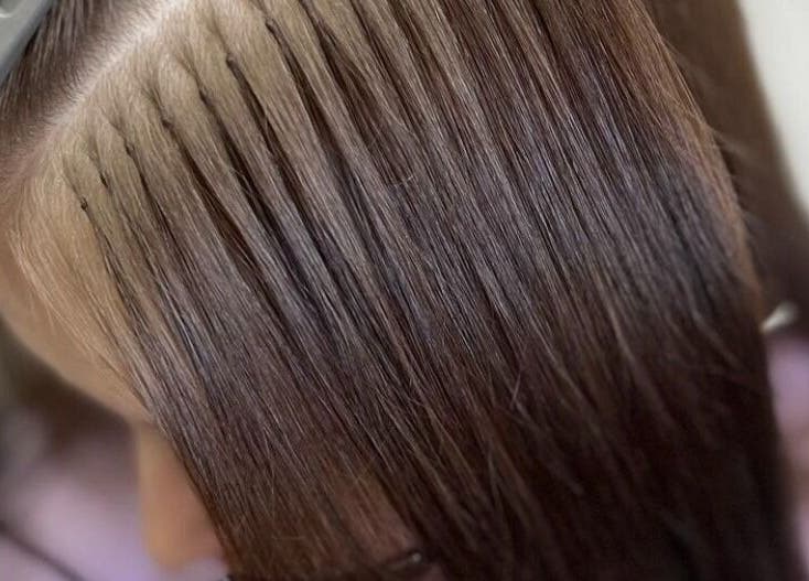Close-up of hair extensions application at Ritzy’s Hair Studio, Windsor, England, GB.
