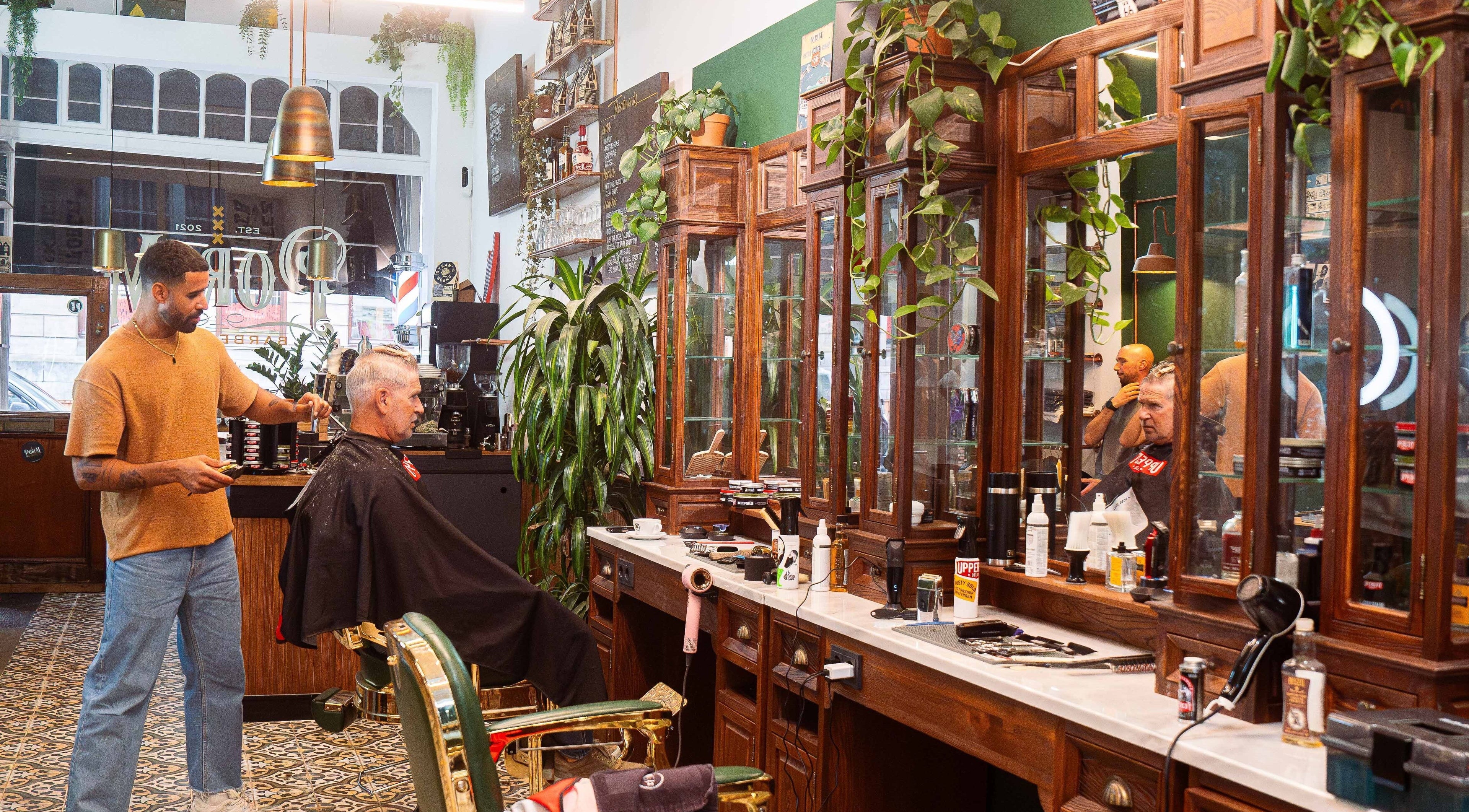Barber styling hair at Porem Damsquare, Amsterdam, Noord-Holland, NL, vintage interior.