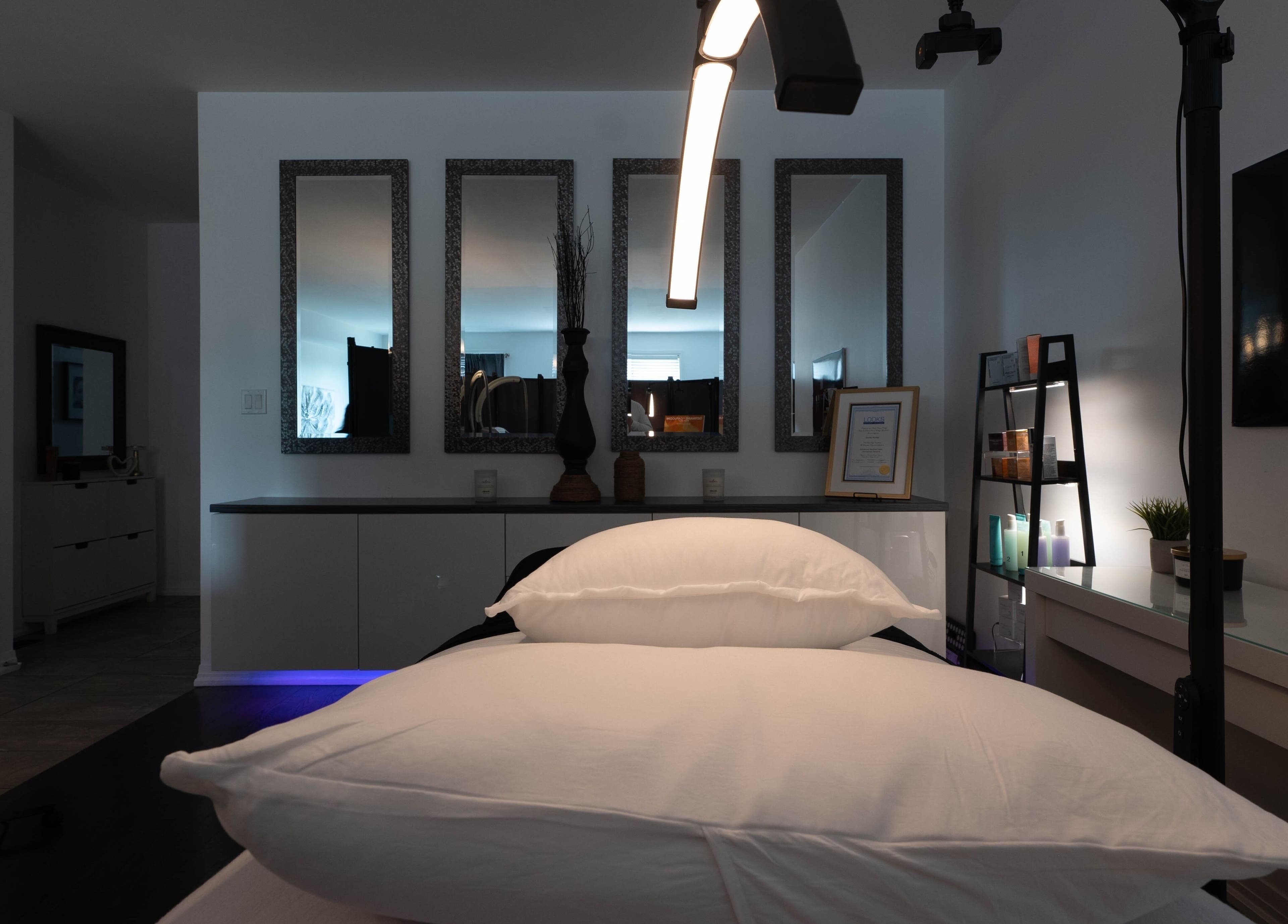 Relaxing treatment room at Diora Med Spa in Milton, Ontario, CA with elegant mirrors and spa equipment.