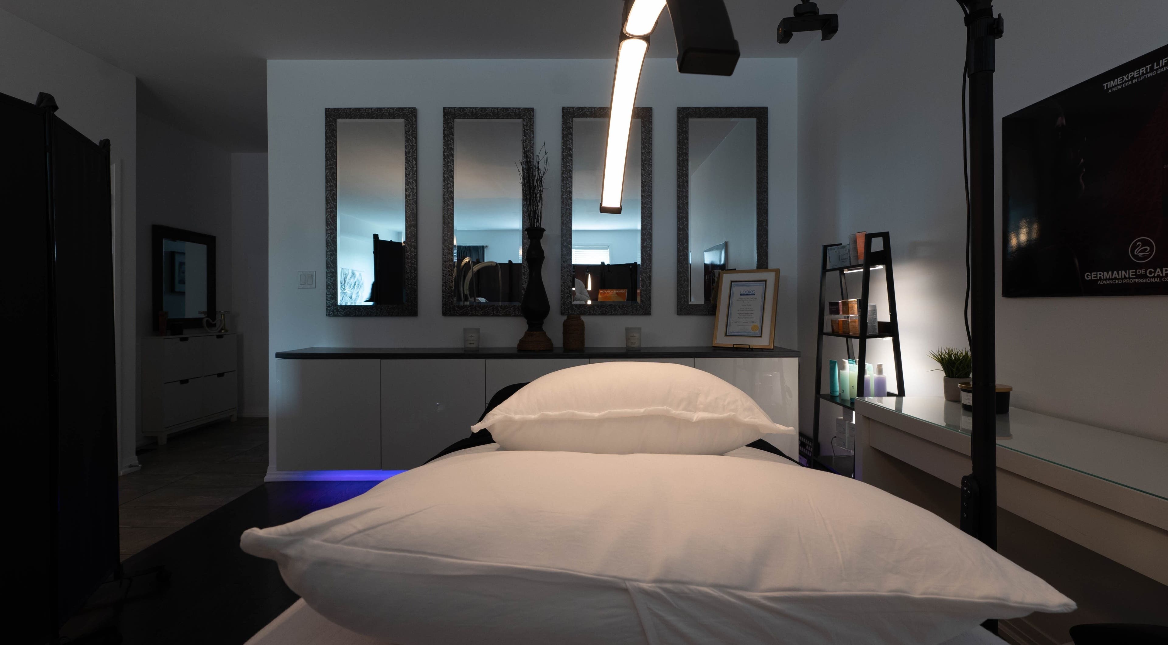 Relaxing treatment room at Diora Med Spa in Milton, Ontario, CA with elegant mirrors and spa equipment.