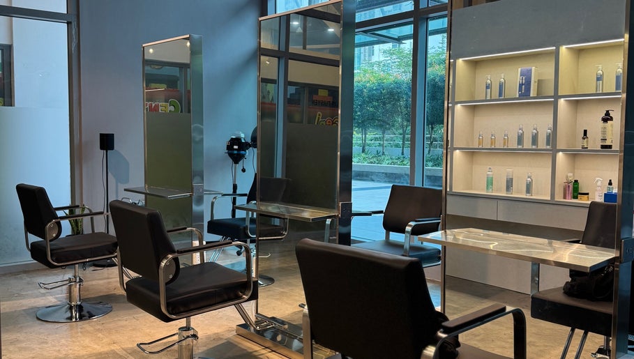 Modern interior of Layers Hair Salon in Kuala Lumpur, featuring sleek styling chairs and product display.