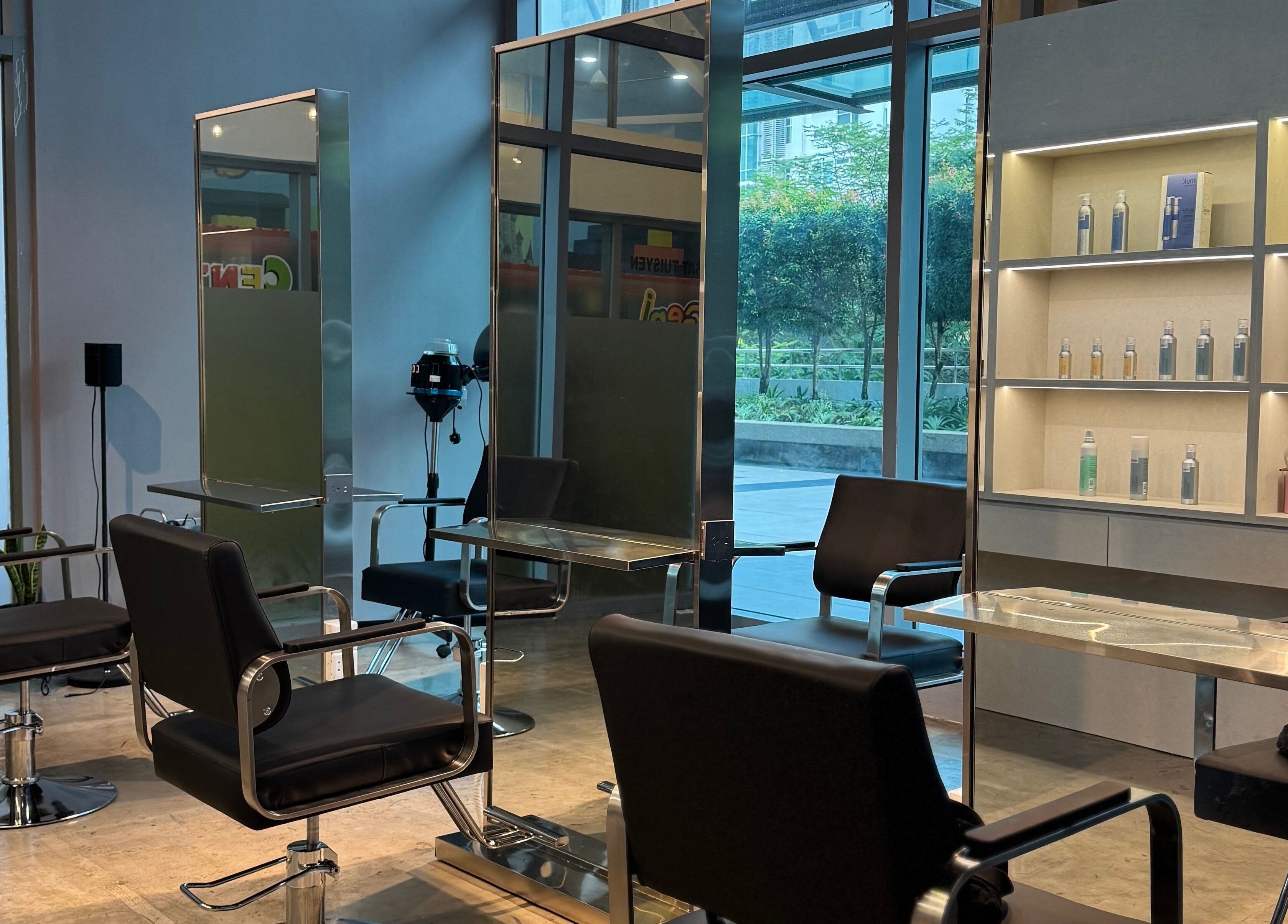 Modern interior of Layers Hair Salon in Kuala Lumpur, featuring stylish chairs and product shelves.