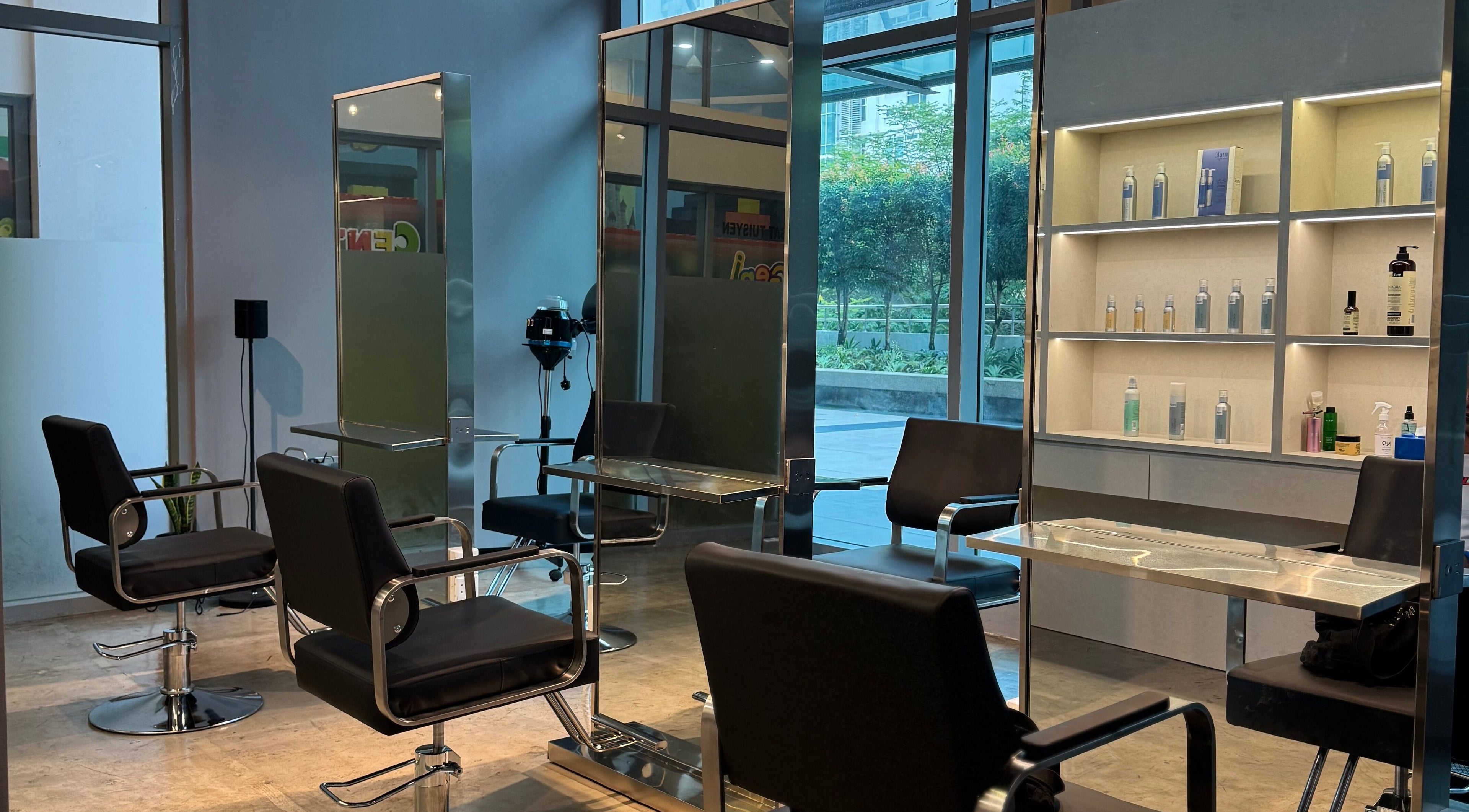 Modern interior of Layers Hair Salon in Kuala Lumpur, featuring stylish chairs and product shelves.