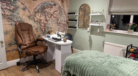 Inviting therapy room at Annabel's Beauty, Stowmarket, England featuring a cozy chair and global map decor.
