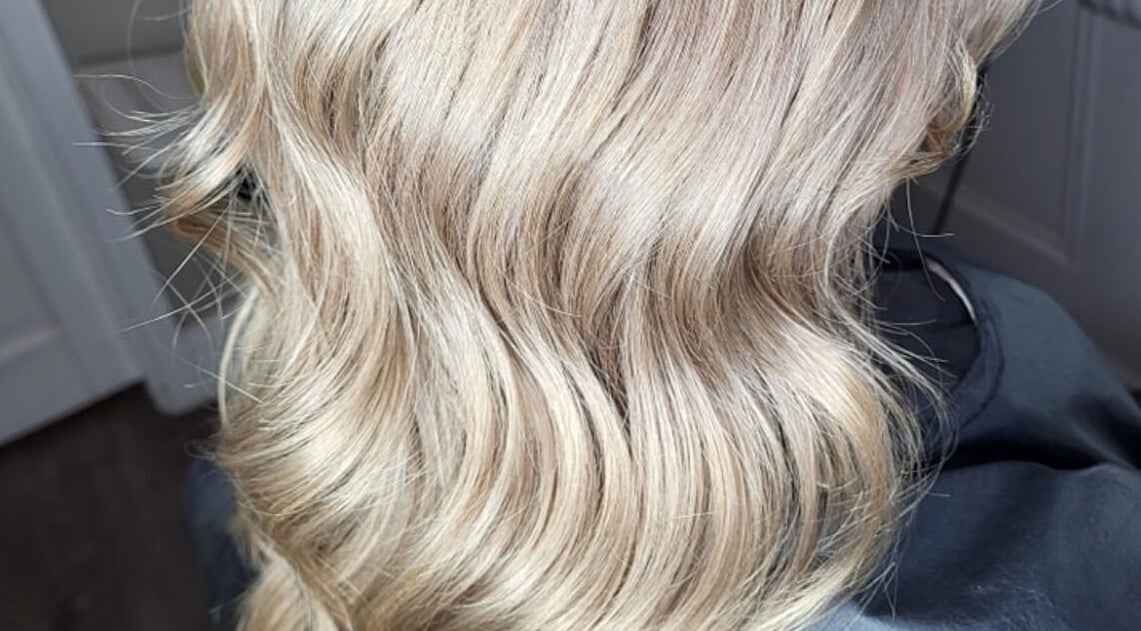 Luxurious blonde waves styled at Norma Murphy Hair in Cork, Munster, IE, highlighting elegant texture.