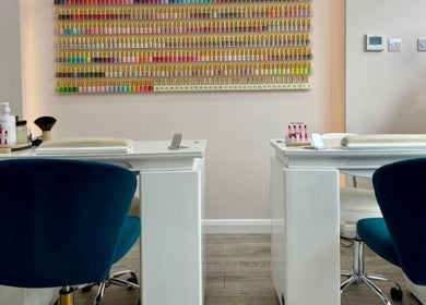 Inside Saint Nails Caterham, a chic nail bar in Caterham, England, GB with colorful polish display and comfy seating.