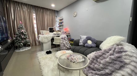 Killynails' relaxing lounge in Singapore, SG with plush furniture and nail care setup beside Christmas decor.
