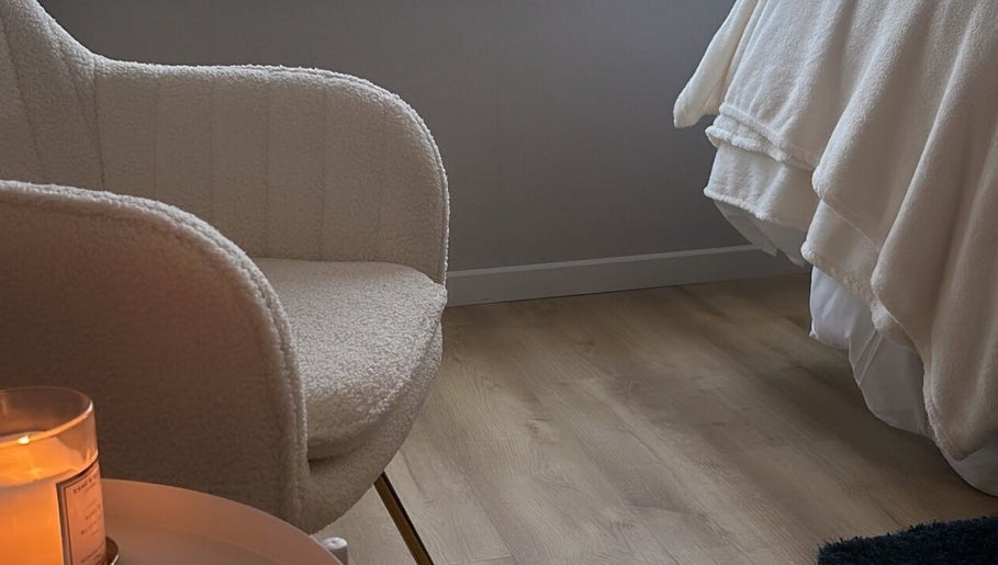 Tranquil corner with chair and candle at Beauty By Aimee, Omagh, Northern Ireland, GB.