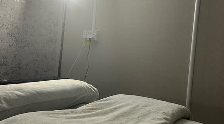 Relaxing treatment bed at Beauty By Aimee in Omagh, Northern Ireland, GB, with soft lighting.