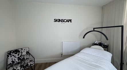 Relaxing therapy room at Skinscape Bristol, located in Bristol, England, GB, featuring a treatment bed and chair.