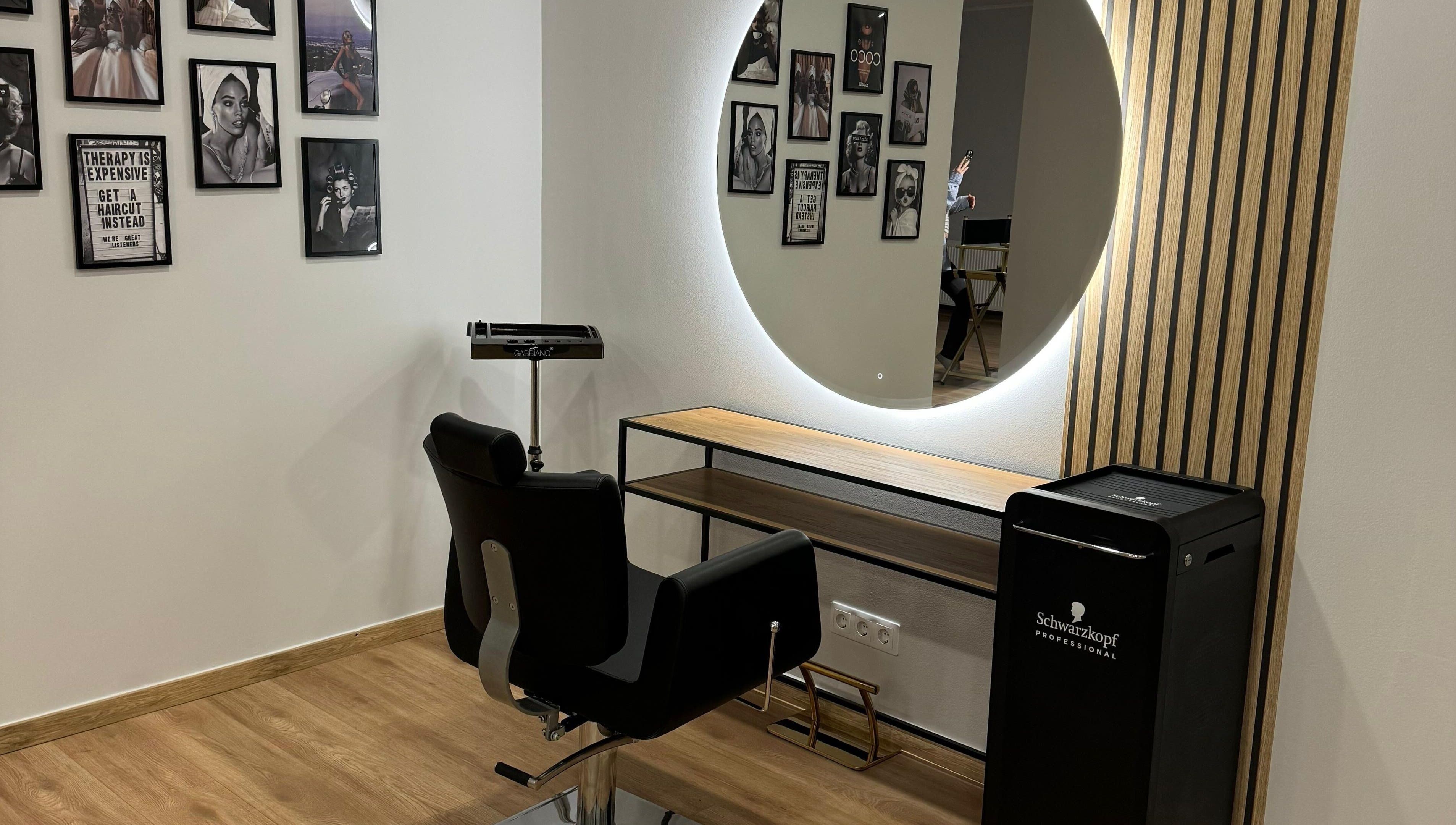 Modern salon chair and mirror at Hair By Sandra, Rīga, LV, showcasing elegance and comfort.