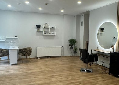 Modern salon interior at Hair By Sandra, Rīga, LV, featuring stylish decor and seating.