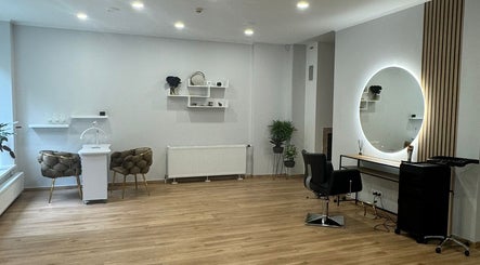 Modern salon interior at Hair By Sandra, Rīga, LV, featuring stylish decor and seating.