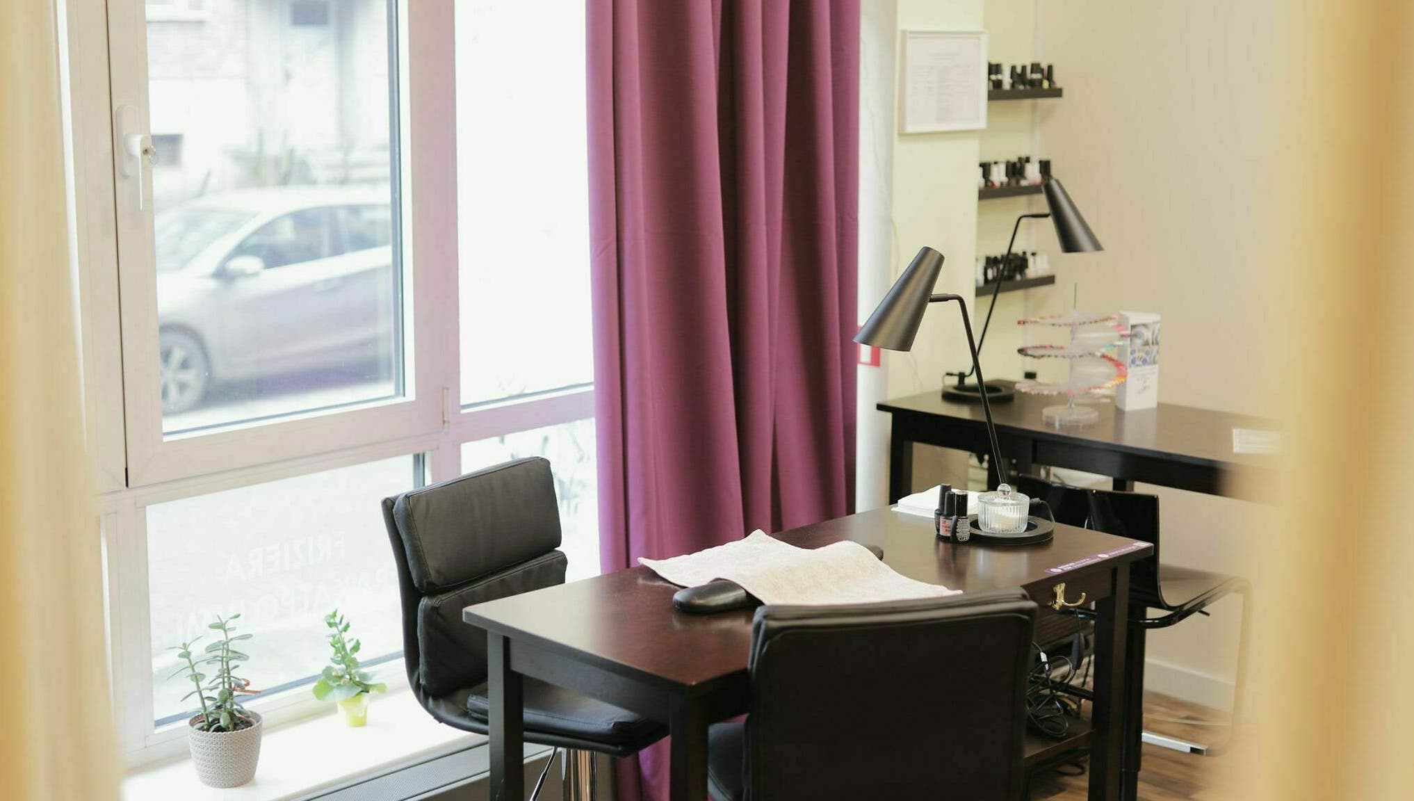 Bright nail salon space at Kluuga Skaistuma Istaba, Rīga, LV with modern desk and natural light.