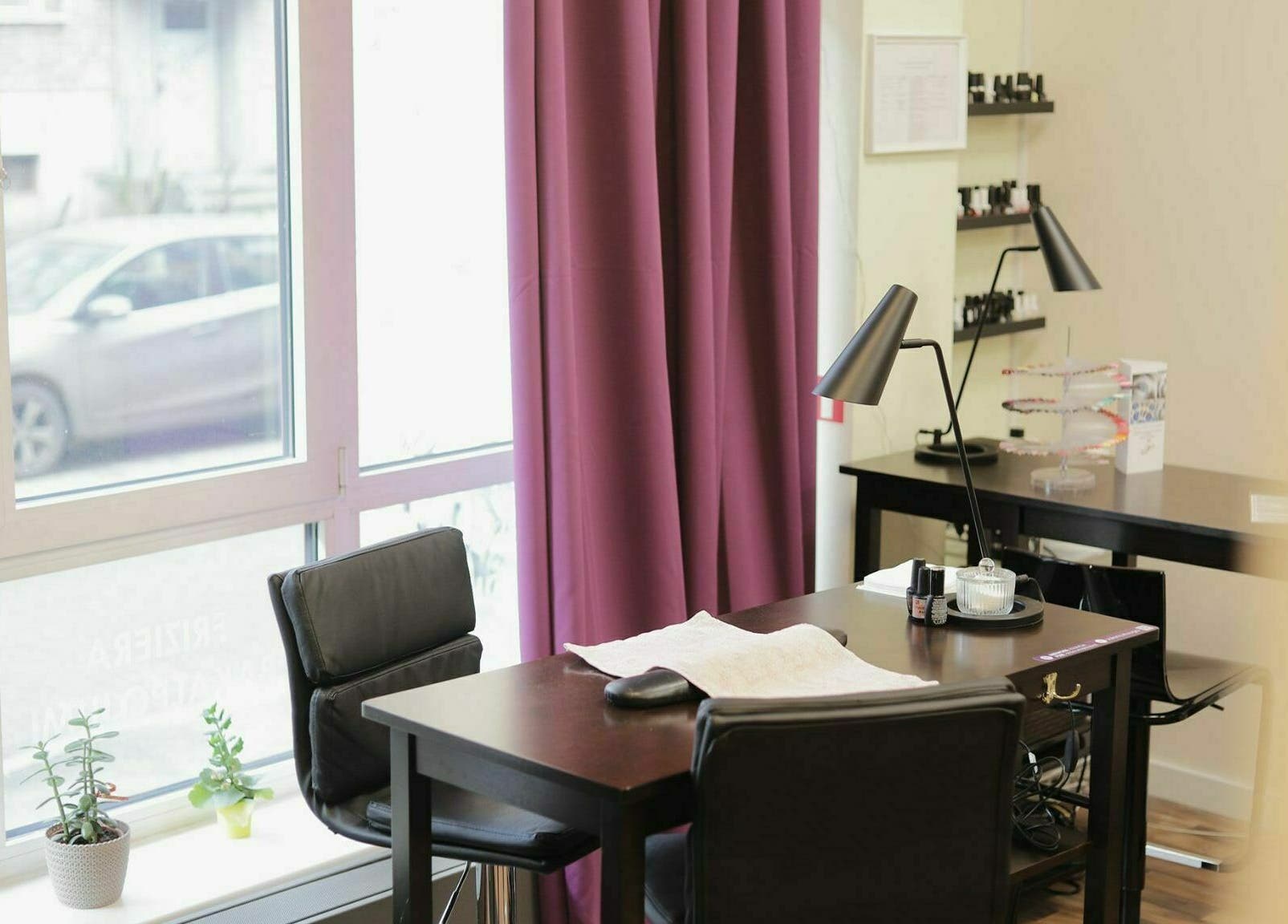 Bright nail salon space at Kluuga Skaistuma Istaba, Rīga, LV with modern desk and natural light.