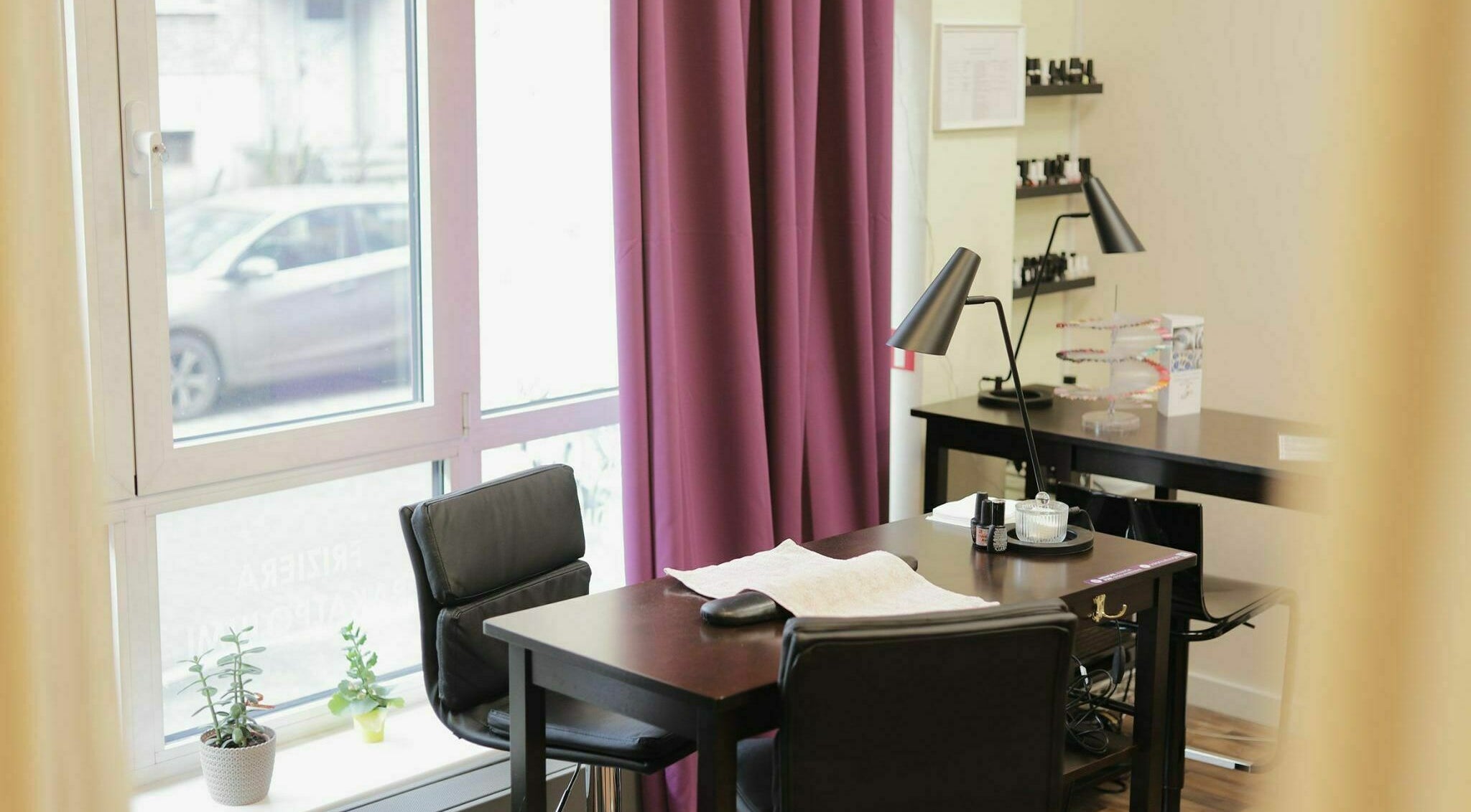 Bright nail salon space at Kluuga Skaistuma Istaba, Rīga, LV with modern desk and natural light.