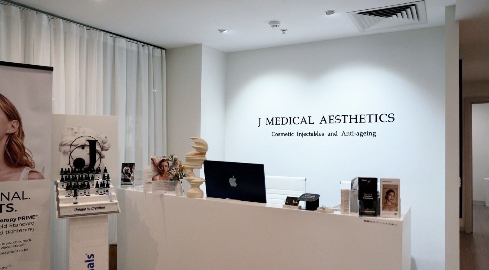 Reception area of J Medical Aesthetics in Melbourne, Victoria, AU, featuring modern decor and product displays.